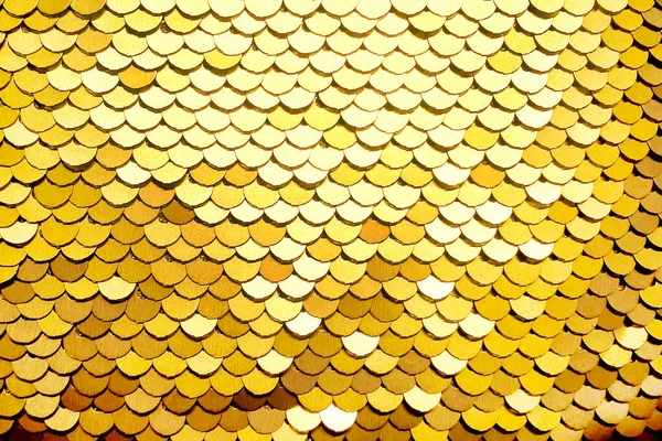 Luxury golden Background. Abstract Texture scales with gold Sequins close-up.