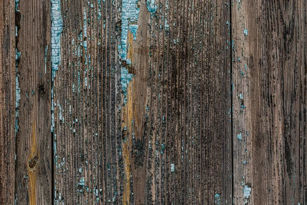 Old rotten wooden boards with peeling paint