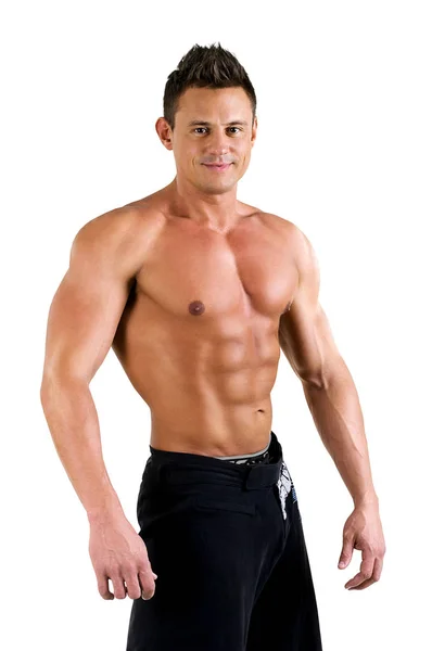 Guapo joven sano con el torso muscular posando sonriente. Aislado sobre fondo blanco Fotos De Stock Sin Royalties Gratis