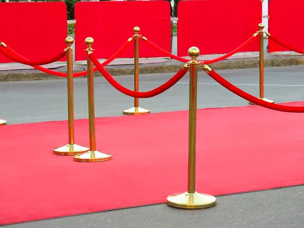 Red carpet entrance with golden stanchions and ropes. Celebrity nominees to premiere. Stars on the festive awarding of prizes awards Stock Picture