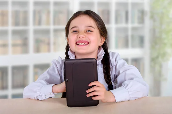 little girl with a tablet. Communication, training, games of a child, a teenager with a modern device. interactive social technologies in the world