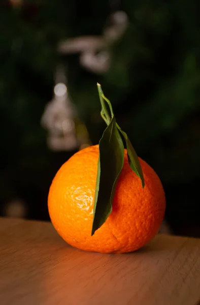 orange mandarin on christmas tree background