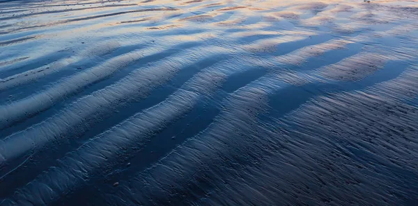 Textuur van natte zand strand — Stockfoto