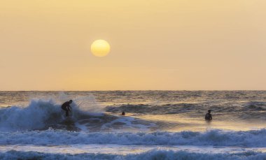 Herzliya, Israel - March 05, 2020: Surfer rides the waves of the Mediterranean Sea