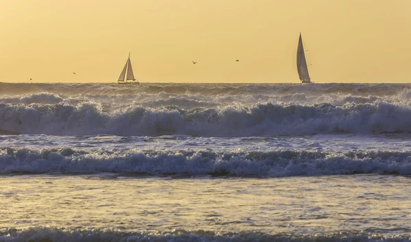 Sailboats sailing in a stormy sea