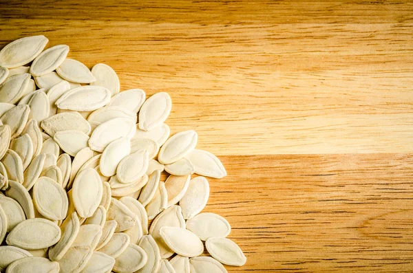 Ahşap arka plan üzerinde kuru kabak çekirdeği