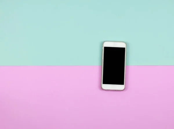 Blank smart phone on blue and pink background. — Stock Photo, Image