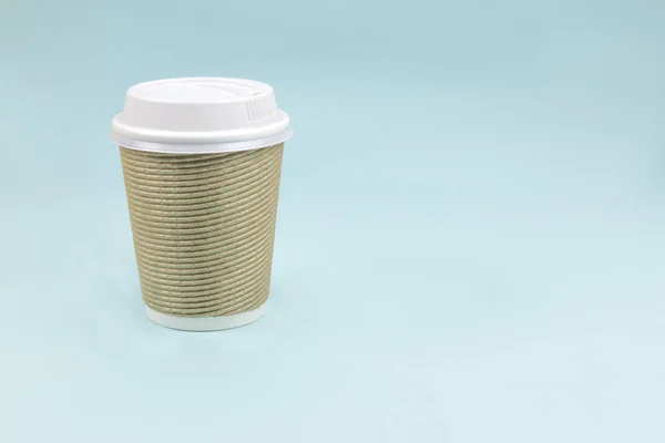 Take out paper coffee cup on blue background.