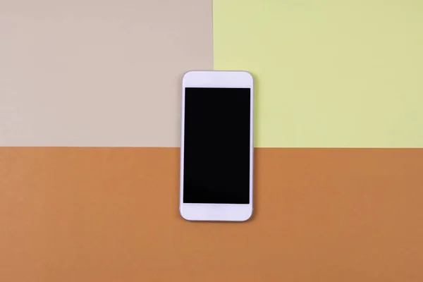 Blank smart phone on cream, yellow and orange background. — Stock Photo, Image