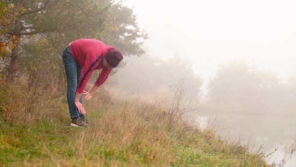 Der Typ macht an einem nebligen Morgen Sport. — Stockvideo