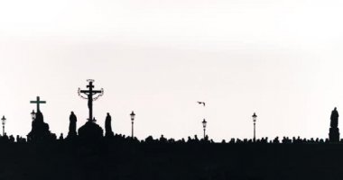 Silhouette, people on the old Charles bridge in Prague.