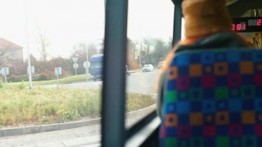 The view from the window of a moving public transport bus.