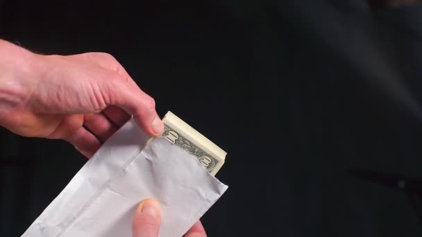 Banknotes one hundred US dollars in a white envelope. — Stock Video