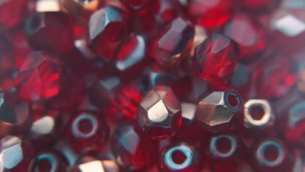 Close-up of red faceted single hole beads. — Stock Video