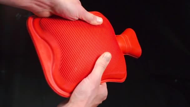 Red medical hot-water bottle in the doctors hands. — Stock Video