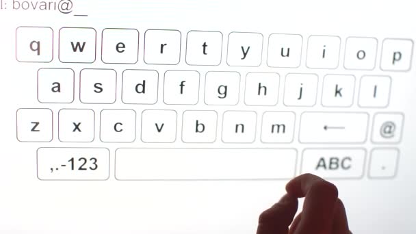 Man presses the letters on the touch keyboard with his finger — ストック動画