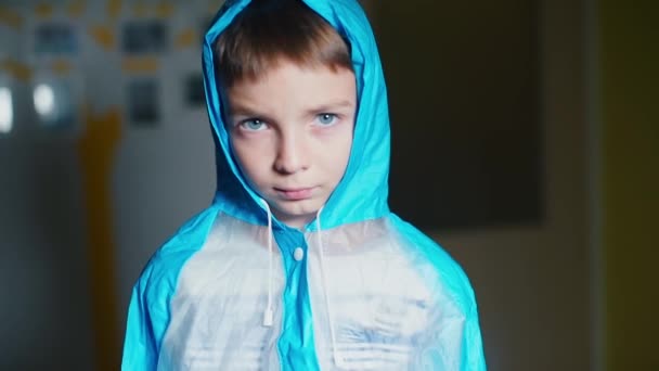 Portrait of a schoolboy who looks at the viewer and turns his back — Stock Video