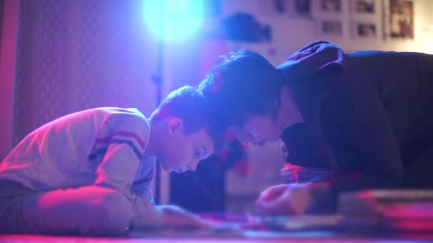 Mom and son read a book together before bed. — Stock Video