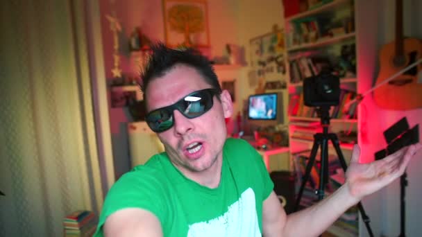 Emotionaler Blogger mit Brille ist nach Diskothekenparty empört. — Stockvideo