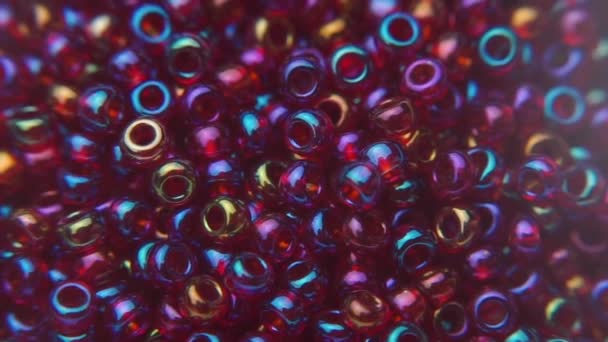 Pouring red beads into a plate during jewelry making. — Stock Video