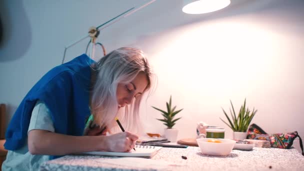 Žena u stolu napíše dopis na papír příteli.. — Stock video