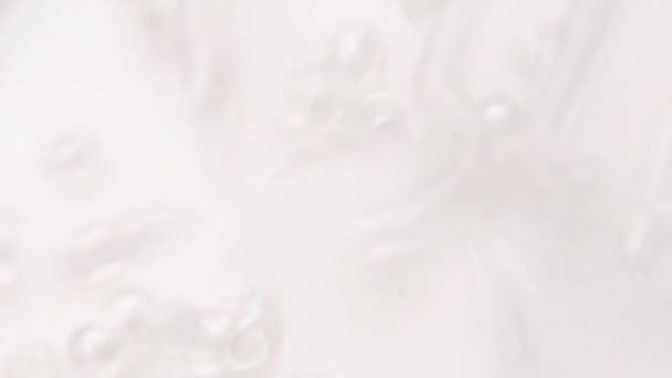 Verser des perles blanches claires dans une assiette blanche .