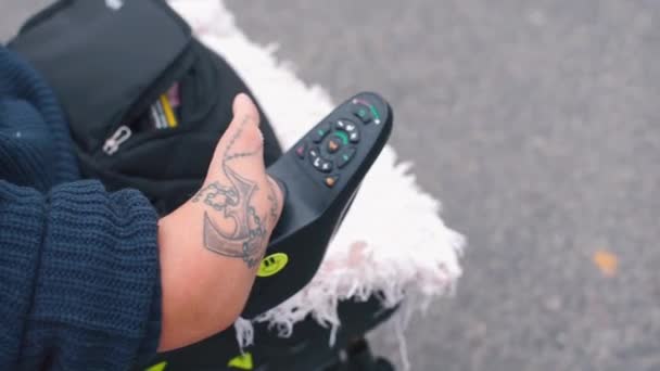 Close-up of hand of disabled person and wheelchair joystick. — Stock Video