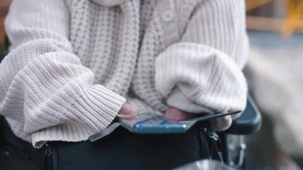 Närbild av att använda en smartphone av en person utan händer. — Stockvideo