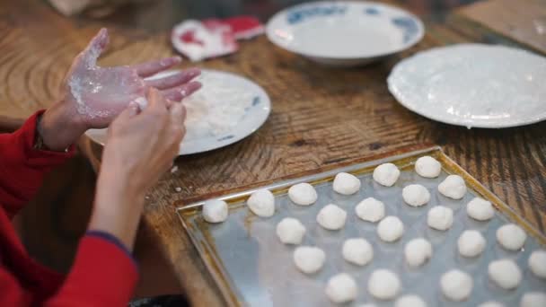 Primer plano de las manos haciendo bolas de masa blanca . — Vídeo de stock