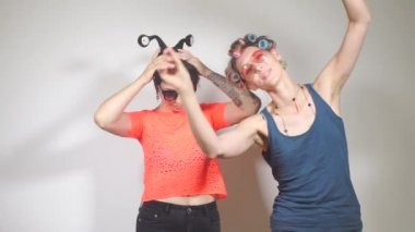 İki kadın çalışan şirket portresini çekmeden önce hazırlanıyorlar.