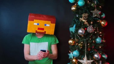 Kare şapkalı bir adam akıllı telefon kullanır.