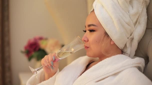 A close-up of the face of an Asian bride drinking champagne. — Stockvideo