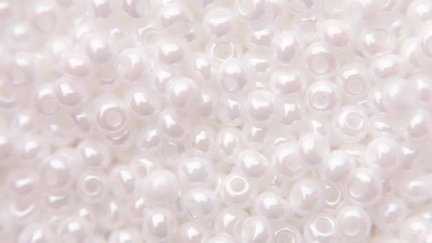 White jewelry beads with one hole. — Stock Video