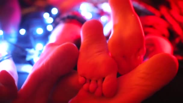 Close-up of the legs of men and women lying on the bed. — Stock Video