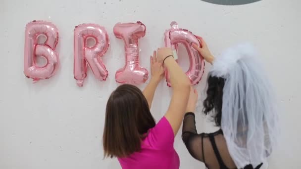 Two girls make an inscription bride — Stock Video