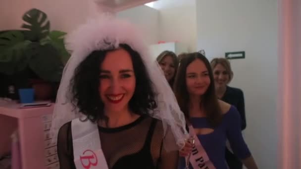 The company of young, cheerful girls comes to a bachelorette party. — Stock Video