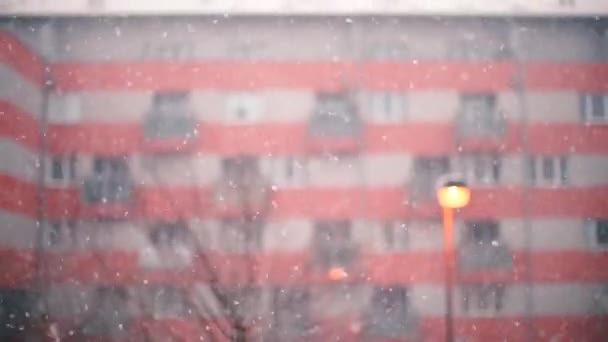 Nieve cayendo sobre el edificio de apartamentos de fondo y linterna en la noche . — Vídeos de Stock