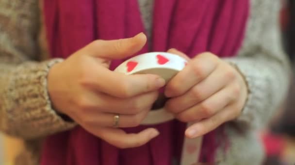 Closeup of a ribbon with drawn heart signs. — Stock Video