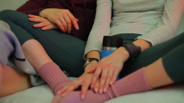 Hands of LGBT partners sitting on a sofa at home. — Stock Video