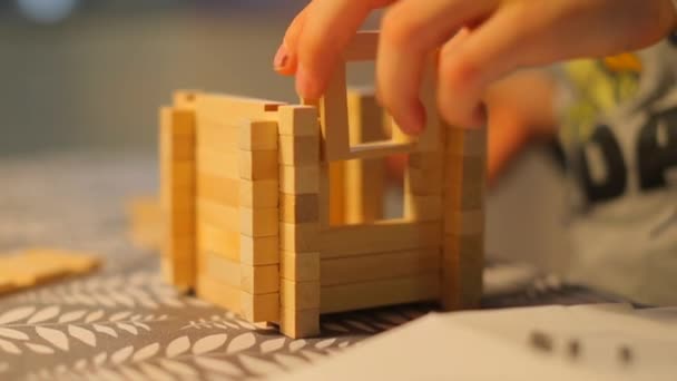 Close-up of the construction of a toy house by a child. — 비디오