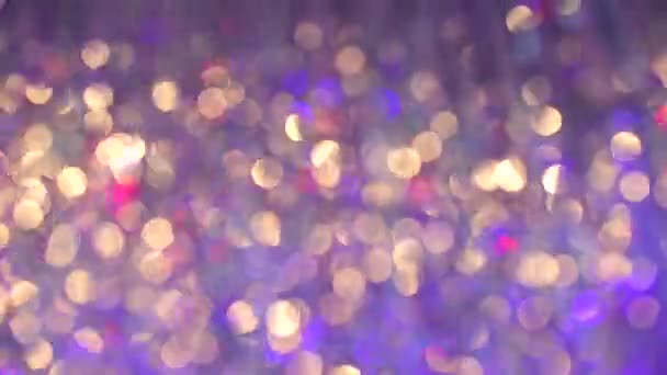 Bokeh etkisindeki parlak röflelerden oluşan arkaplan — Stok video