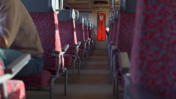 Suburban train in motion. A man is sitting in the passenger seat. — Stock Video