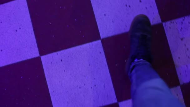 Man in a state of drug intoxication walks on the floor in a nightclub at party. — Stock Video