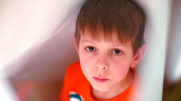 Portrait of a relaxed boy on a white background. — Stock Video