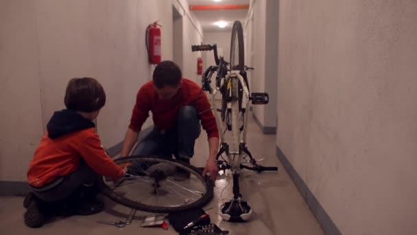 Father and son change tires in the wheel. — Stock Video