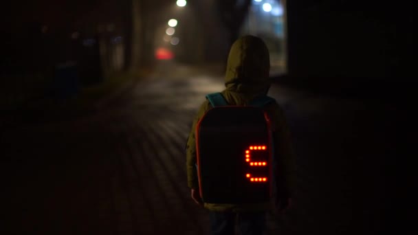 Lonely schoolboy on the road at night. — Stock Video