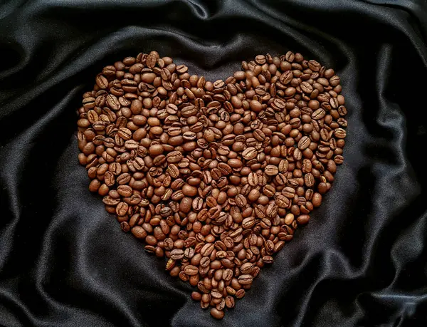Coffee beans in the shape of a heart. Love for coffee. Valentines day.