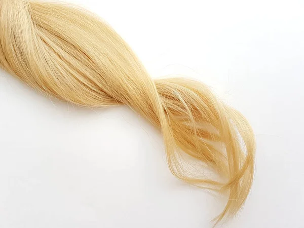 Curls of natural blonde hair on a white background. — Stock Photo, Image