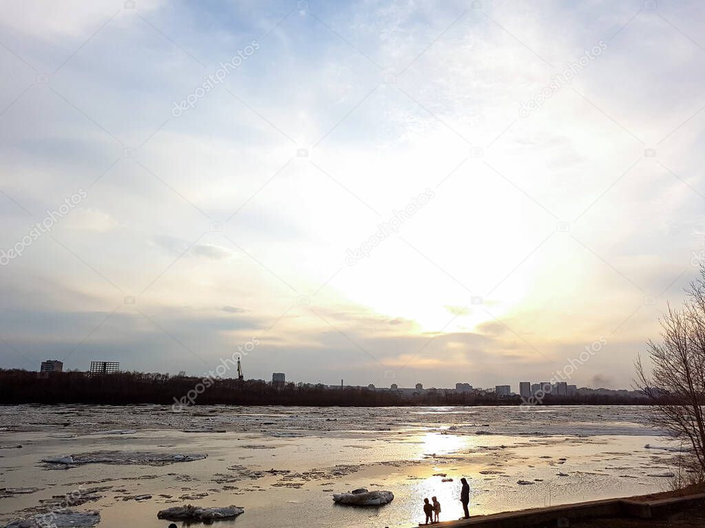 The movement of ice on the river against a sunset.