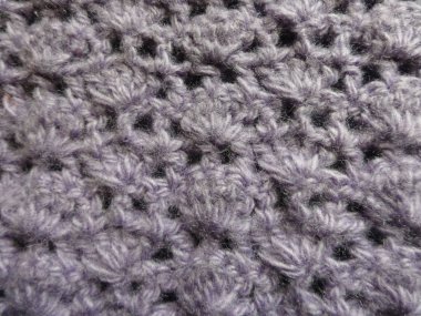 Örgü örülmüş kumaş, arka plan ya da dekorasyon için çiçek şeklinde örülmüş desen.